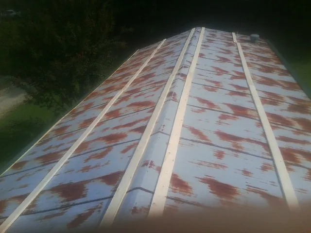 Rusted metal roof panels with new wood purlins before replacement — Storm Damage Roof Repair in Nanjemoy by Roofing Brothers